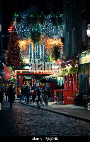 A vertical shot of a beautiful building with Christmas lights and decorations in Dublin, Ireland at night Stock Photo