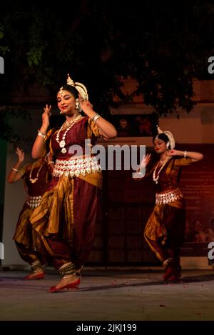 A photo of young Indian female artists performing Indian classical Odissi dance on stage at Pushkar Camel Fair Stock Photo