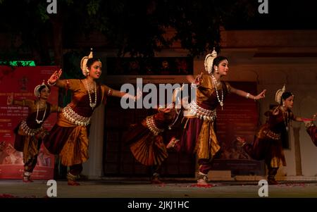 A photo of young Indian female artists performing Indian classical Odissi dance on stage at Pushkar Camel Fair Stock Photo