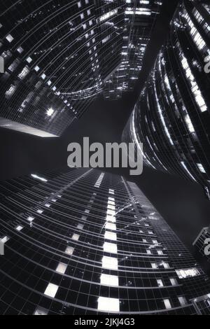 A gray scale of low angle shot of tower buildings in Moscow-city during night Stock Photo