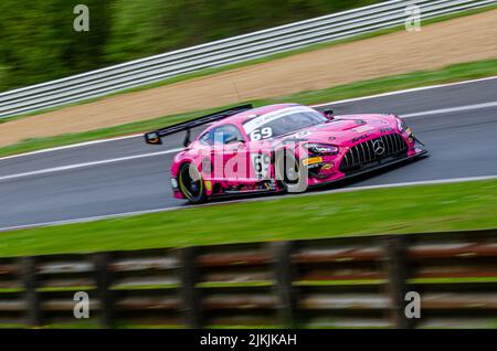 A long exposure shot of a Mercedes-AMG GT3 pink car during the race in the British GT Championship, Stock Photo