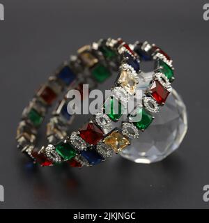 A closeup shot of traditional silver bangles with colored crystals Stock Photo