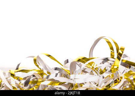 A closeup of gold and silver streamer isolated on a white background - copy space Stock Photo