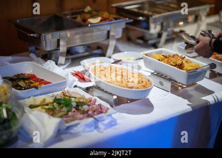 A selective focus shot of a casserole with cheese at the catering food buffet table Banque D'Images