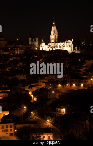 A vertical distant view of the Primatial Cathedral of Saint Mary at night in Toledo, Spain Stock Photo