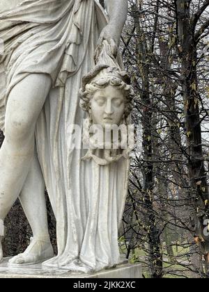 A vertical closeup shot of the cut off Medusa head Statue in Schoenbrunn, Vienna, Austria Stock Photo