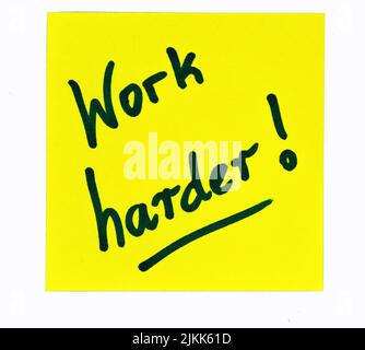 A black-colored inspirational motivating quote saying "work harder!" on a yellow post-it Banque D'Images