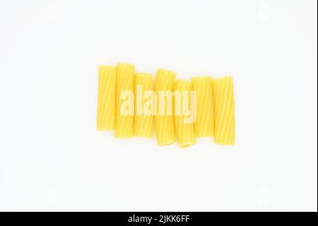 A top view of raw penne pasta on a white background Banque D'Images