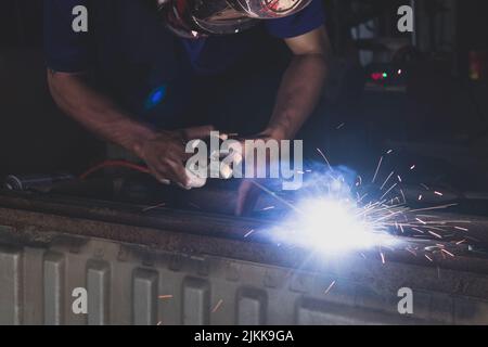 A welder welding automotive part in a car factory Stock Photo