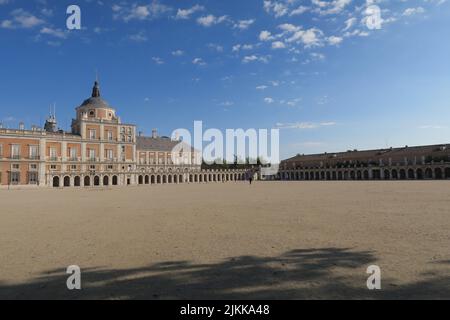 A beautiful shot of the Royal Palace of Aranjuez against blue sky in bright sunlight in Aranjuez, Spain Stock Photo