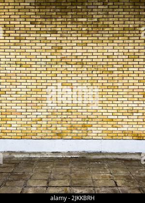 A vertical frontal shot of an exterior brick wall pattern. Stock Photo