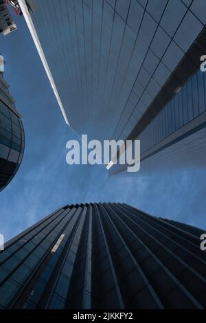A low angle shot of two skyscrapers with dark cloudy sky Banque D'Images