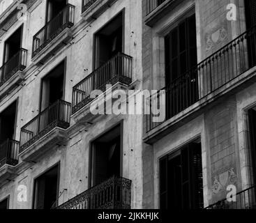 A black and white image of an old European apartment building in the city center with small balconies Stock Photo