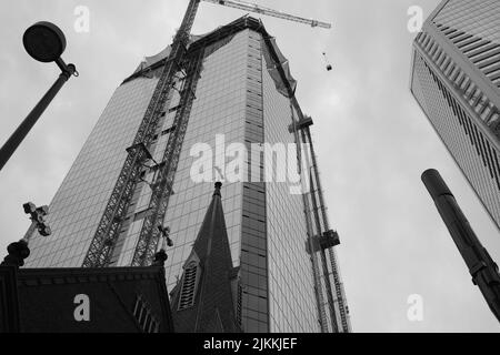 A vertical low angle grayscale view of a skyscraper being built in Charlotte, North Carolina, USA Stock Photo