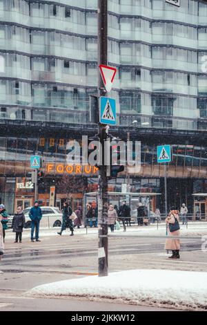 A vertical shot of traffic lights in a busy street on a winter day in Estonia Stock Photo