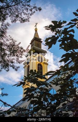 A low angle shot of church tower against blue cloudy sky at sunset in Fruska Gora, Serbia Stock Photo