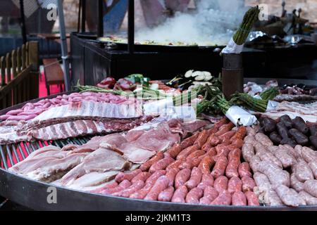 A closeup shot of fresh meat and vegetables displayed in a market Stock Photo