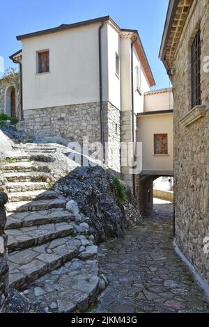 A vertical shot of narrow street between the old houses of Montecosaro ...