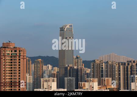 A scenic view of skyscrapers and dense highrise buildings under the clear sky in Hong Kong, Tsuen Wan Stock Photo