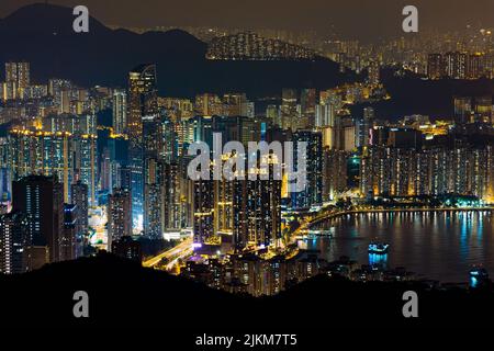 A scenic view of skyscrapers with illuminated lights in Hong Kong, Tsuen Wan Stock Photo