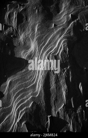 A grayscale shot of the sand dunes in the desert Stock Photo