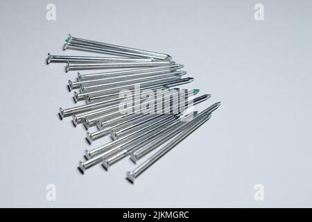 The heap of construction nails isolated on a white background Stock Photo