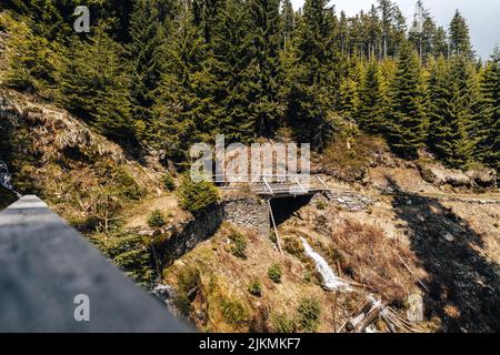 Mountain stream with a wooden bridge in Krkonose National park, Czechia. Mountain creek in Giant Mountains, Bohemia. Stock Photo