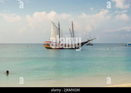 Jolly Pirates sailing vessel seen from Aruba beach. Sea view from Palm Beach, Aruba. Calm ocean view from beach. Stock Photo