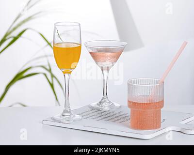 Three types of different cocktails on a cutting board on the table Stock Photo