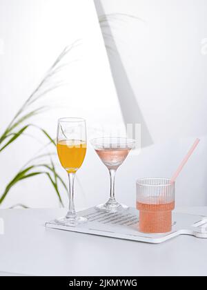 Three types of different cocktails on a cutting board on the table Stock Photo