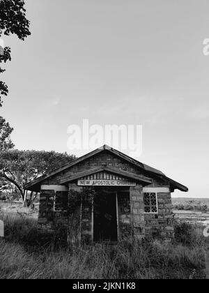 a low angle shot of old stone church in grayscale Stock Photo