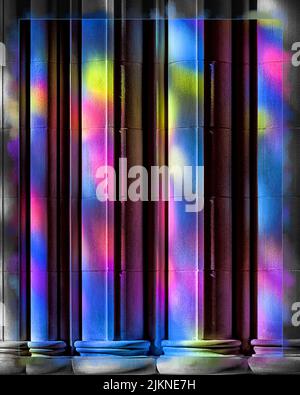 A beautiful shot of colorful, purple, pink and blue lights reflecting on stone texture huge marble poles Banque D'Images