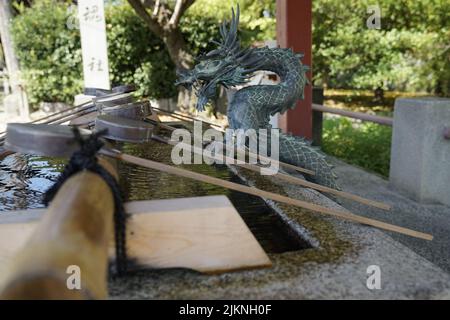 A bronze dragon fountain in a Japanese Shinto shrine Stock Photo