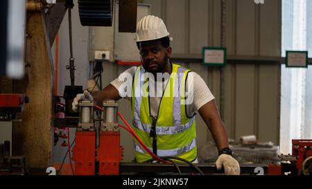 Industrie lourde Foreman Ingénieur sécurité blouson sécurité entretien préventif quotidien vérifier machine dans l'usine de fabrication, utiliser presse-papiers, avoir discussion Banque D'Images