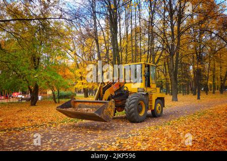 A yellow wheel loader in the park in Saint Petersburg, Russia Stock Photo