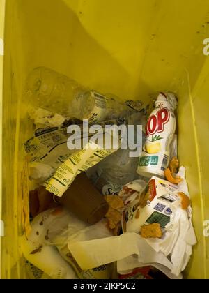 Yellow trash bin full of plastic waste inside a hospital in Morocco Banque D'Images