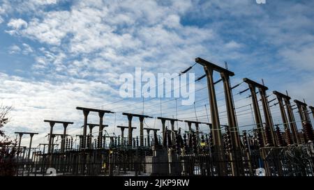 A closeup of an Electrical substation with a blue sky background Stock Photo