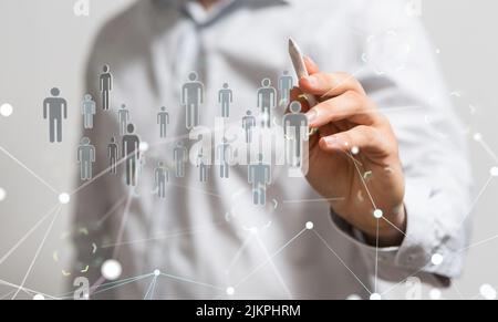 A closeup of a hand holding a 3D rendered group of people for community and management concept Stock Photo