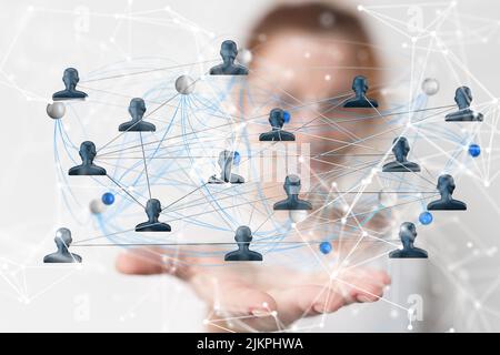 A 3D rendering of grey human figures floating above a women's hand connected with lines Stock Photo