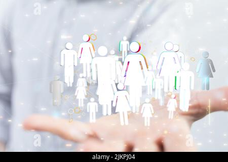 A 3D illustration of white human figures showing connection and network floating above a hand Stock Photo