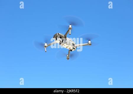DJI Mavic drone dans l'air contre un ciel bleu Banque D'Images