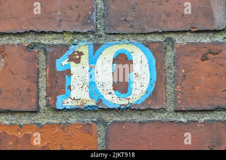 A photo of number 10 painted on a brick wall background Stock Photo