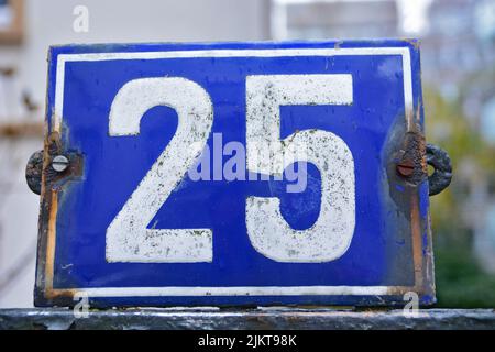 A closeup shot of the number twenty five sign on a blue background Stock Photo