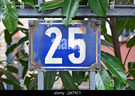 A closeup shot of the number twenty five sign on a blue background Stock Photo