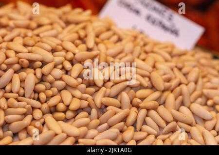 Bulk peeled pine nuts ready for sale at the Boqueria market in Barcelona (Spain), selective approach. Stock Photo