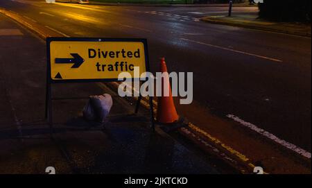 A 'Diverted Traffic' temporary road sign on a rainy road Stock Photo