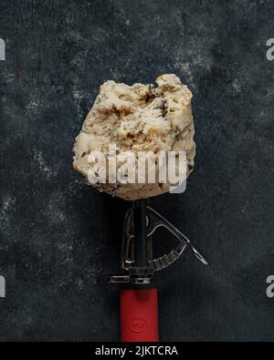 A top view of tasty rum and raisins ice cream ball isolated on a grey background Stock Photo