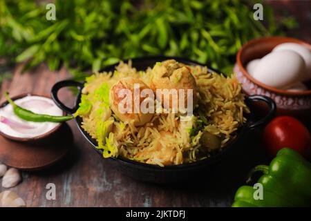 A closeup of Indian traditional dish Biryani with chicken meat on a plate Stock Photo