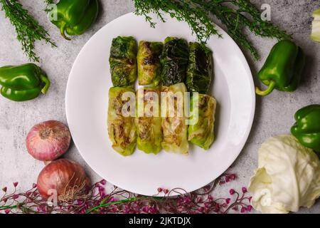 A top view of stuffed cabbage rolls with minced meat on a white plate Stock Photo