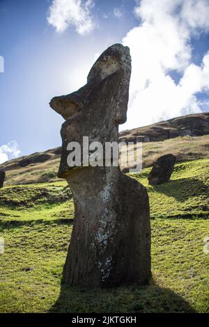 A vertical closeup of an antique Moai stone statue on Easter Island, Chile Stock Photo